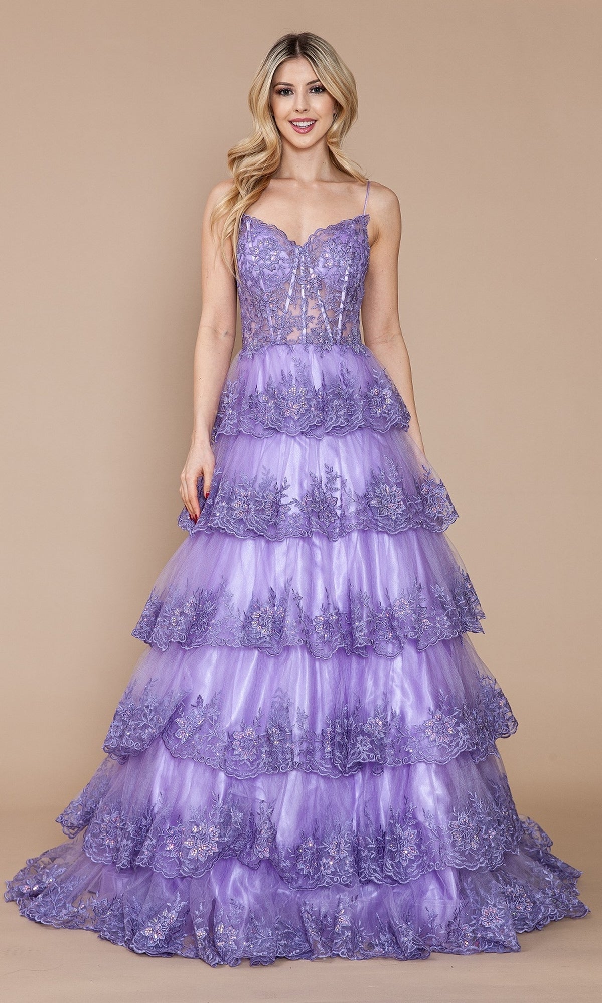 A woman poses against a plain beige background in the Sheer-Bodice Long Ruffle Prom Ball Gown: Poly 9402, featuring a lavender hue, embroidered-lace bodice, spaghetti straps, and long ruffled skirt.